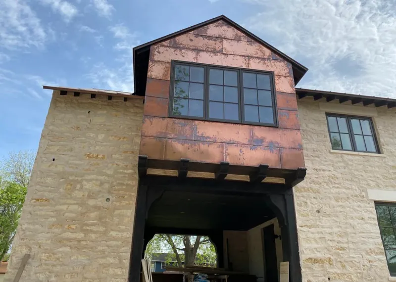 Copper metal panel facade on a stone building for Metal Roof Coating in Cascades