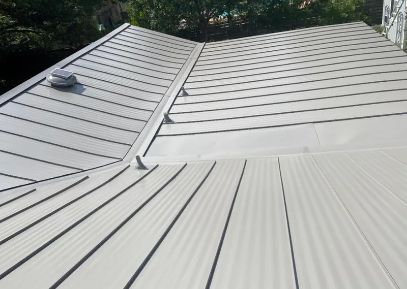 Solar attic fan installed on a metal roof for Roof Ventilation in Cascades